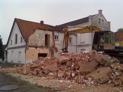 house demolition by excavator