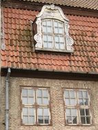 glass windows on the walls and roof of the building