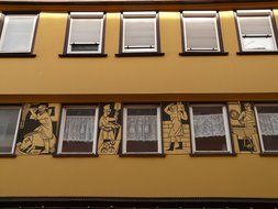 facade of a building with crafts painting at windows, germany, reutlingen