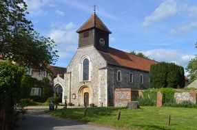 facade of the village church with the plants at noon