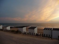 fenced beach at sunset, netherlands