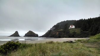 distant view of a house on a hill on the pacific ocean in oregon