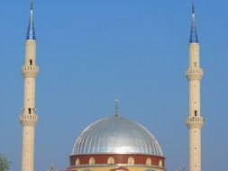 Dome and minarets of the mosque against the background of the clear sky