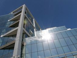 modern office building reflects the sun