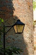 lantern near a brick tower