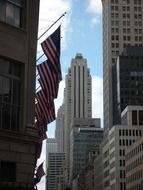 us flags on the background of high-rise buildings in New York