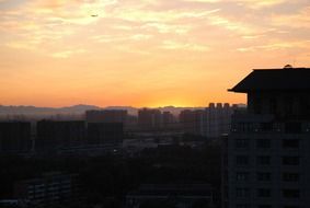 china golden sunrise with airplane flying