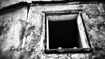 black and white photo of a window on a wooden house