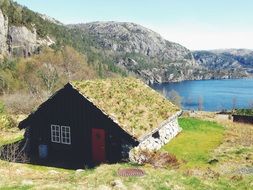 stone framed hut at mountain lake