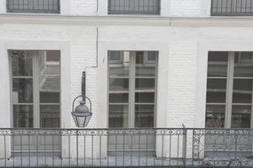 balcony on brick white building in France