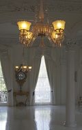 white hall with a large chandelier