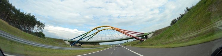 photo of a colored bridge across the road