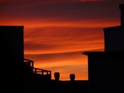 the roofs of houses at sunset