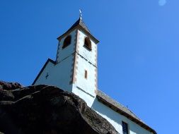 Blue church on a cliff