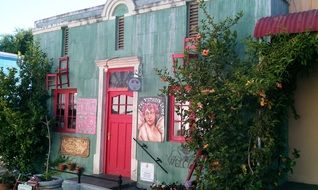 bright painted facade of old building with chairs above windows, south africa, riebeek kasteel