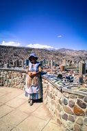 woman in hat in view of city, bolivia, la paz