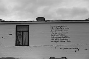 poetry on the white wall of a house in Iceland