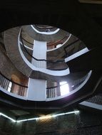 bottom view of the staircase architecture with light in the windows