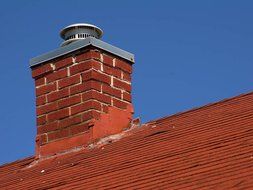 brick chimney on the roof of a rural house