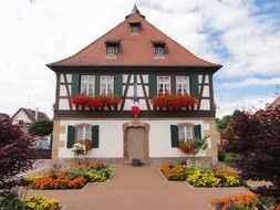 house with flowers on balconies in france