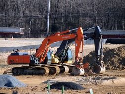 excavators at construction site on sunny day