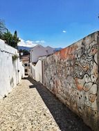 concrete wall with graffiti on the street