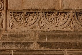 floral pattern, ancient carving on stone wall, india