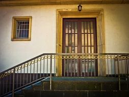 brass staircase near the front door of a vintage house