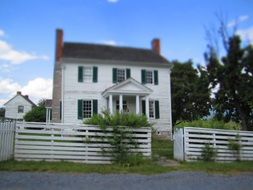 white fence near the house