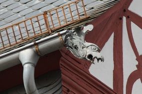 Gargoyle head on the house as decoration