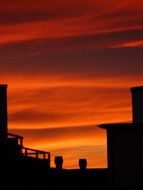 roofs on a background of the fiery sky