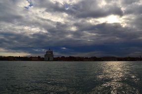 canal in venice under dark clouds
