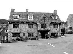 old stone house with chimneys on roof