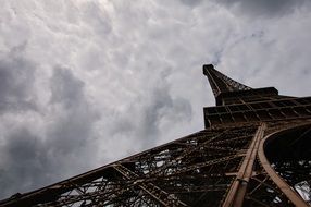 Eiffel Tower on the background of the cloudy sky