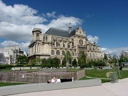 man rests on square in view of Saint-Eustache church, france, paris