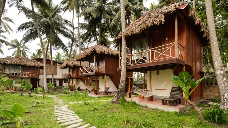 hotel with small bungalows among the palms