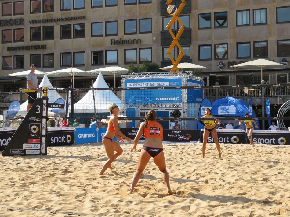 Beach volleyball game against the building background