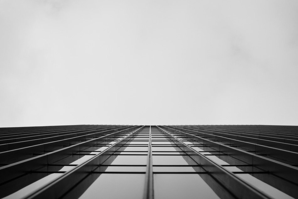 bottom view of flat mirror glazing of a skyscraper