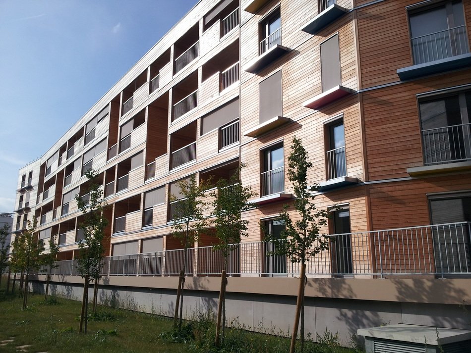 facade of new long wooden low consumption building
