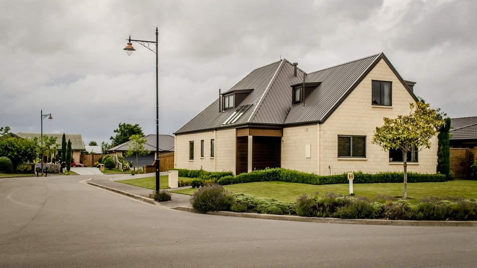 one-storey house on lawn at road in village, new zealand