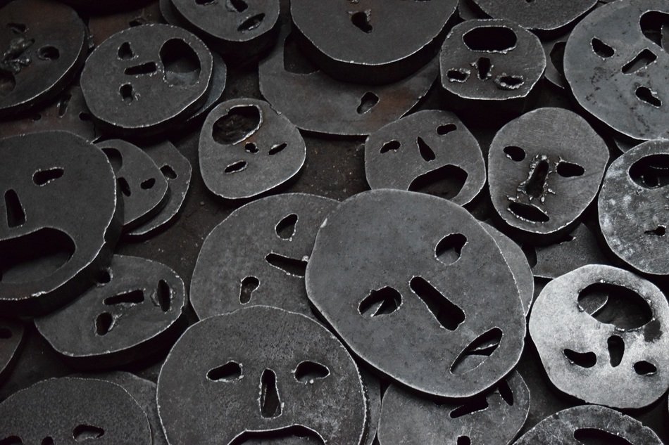 A lot of metal faces in a pile