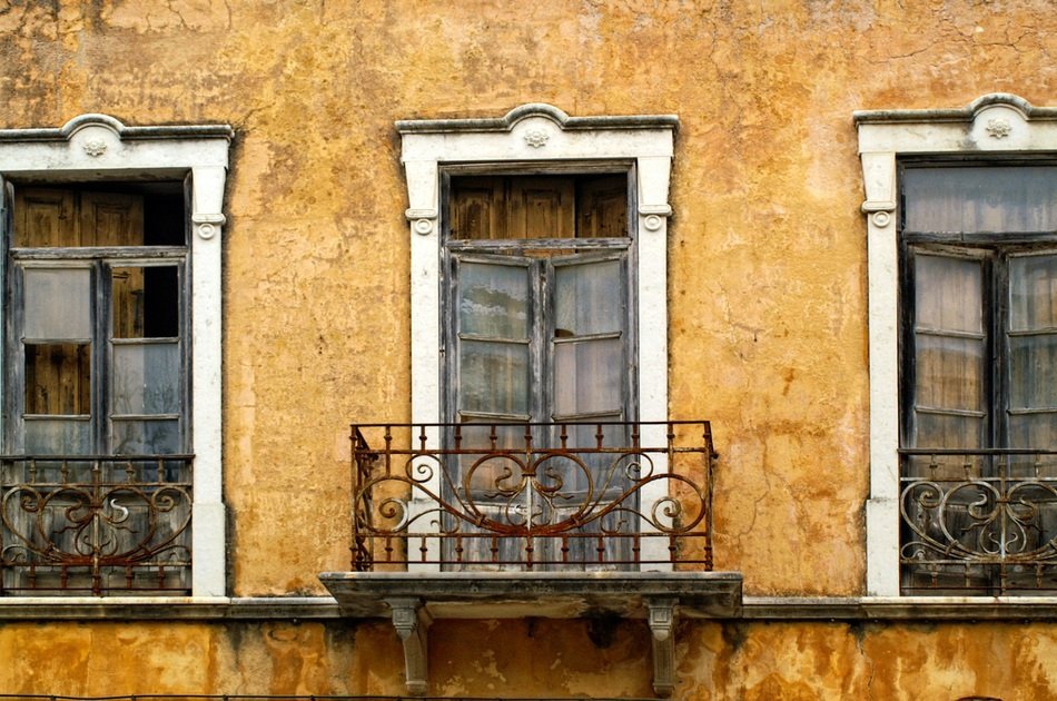 balconies on the yellow home front in Portugal