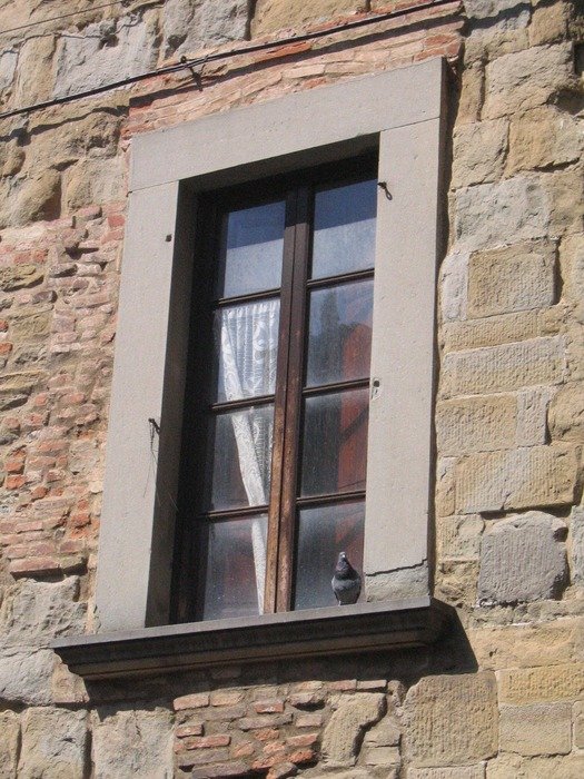 The stone wall with window on it