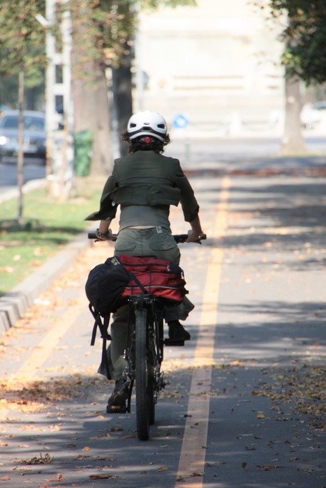 cyclist in a city park in the shadow
