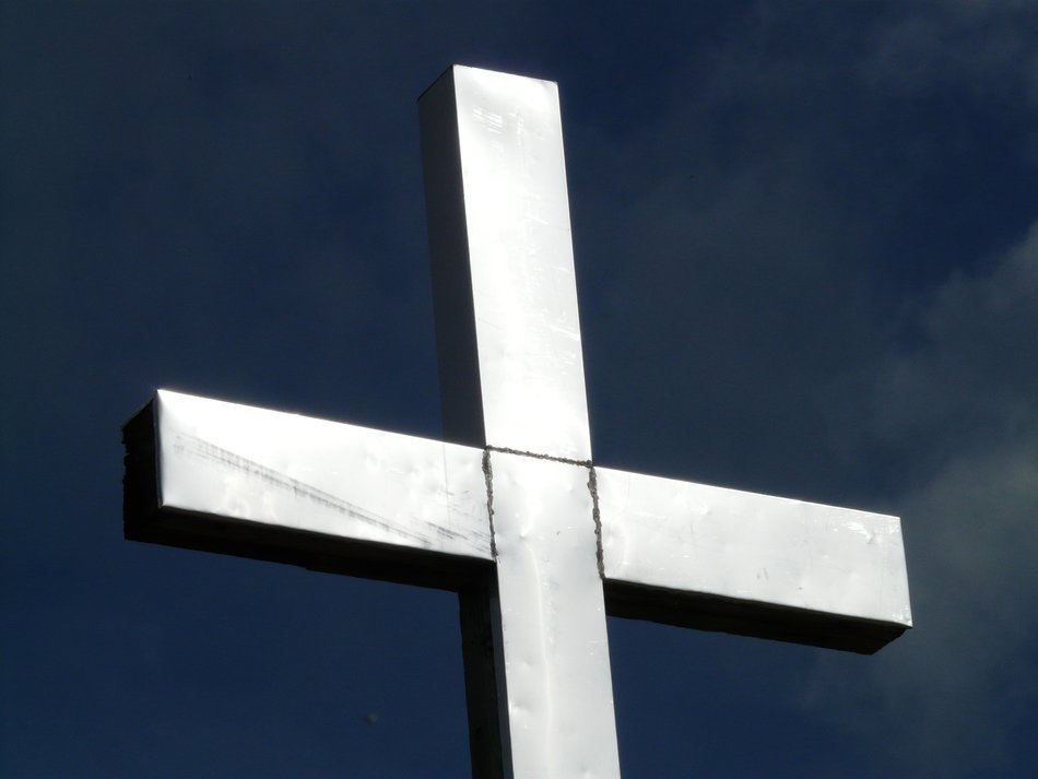 photo of silver cross under the sunshine