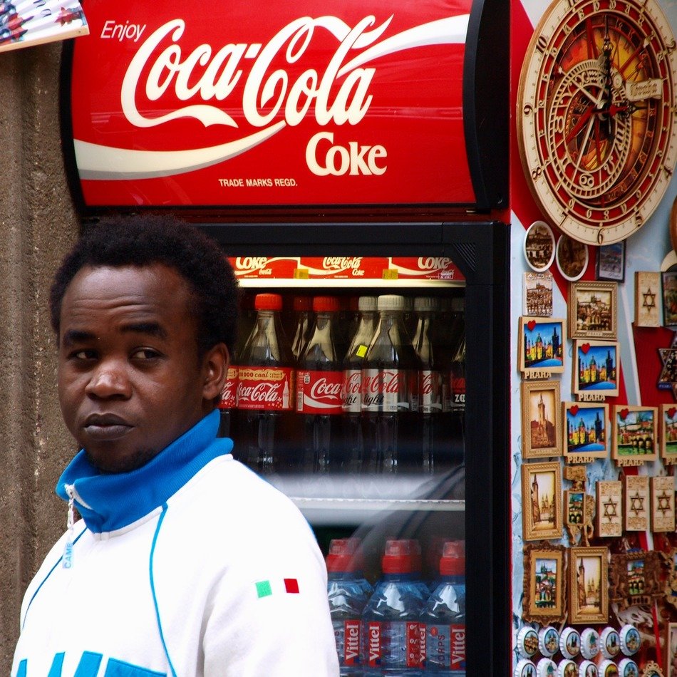 african man near the fridge with drinks