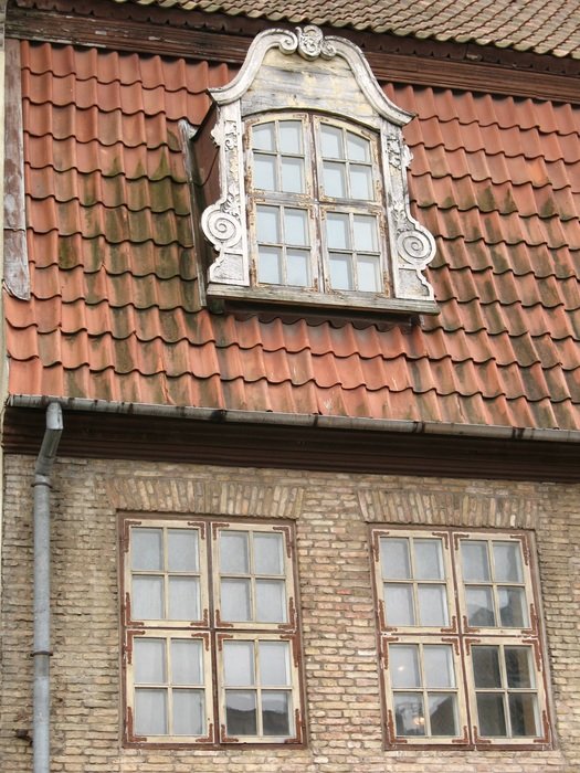 glass windows on the walls and roof of the building