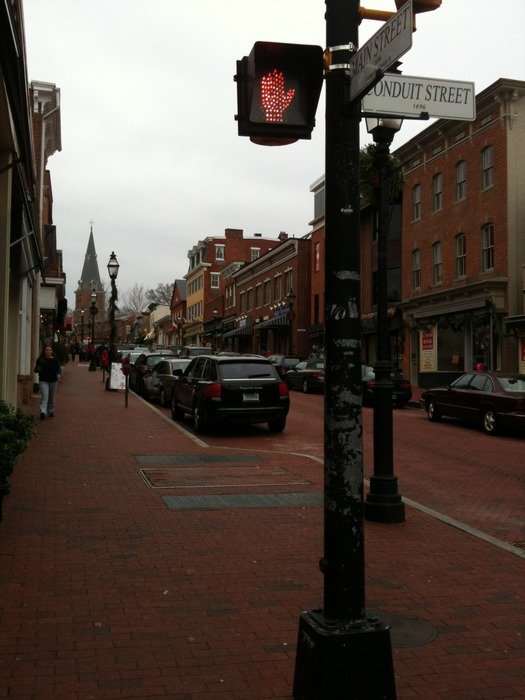 traffic lights on pillar at crosswalk in old city