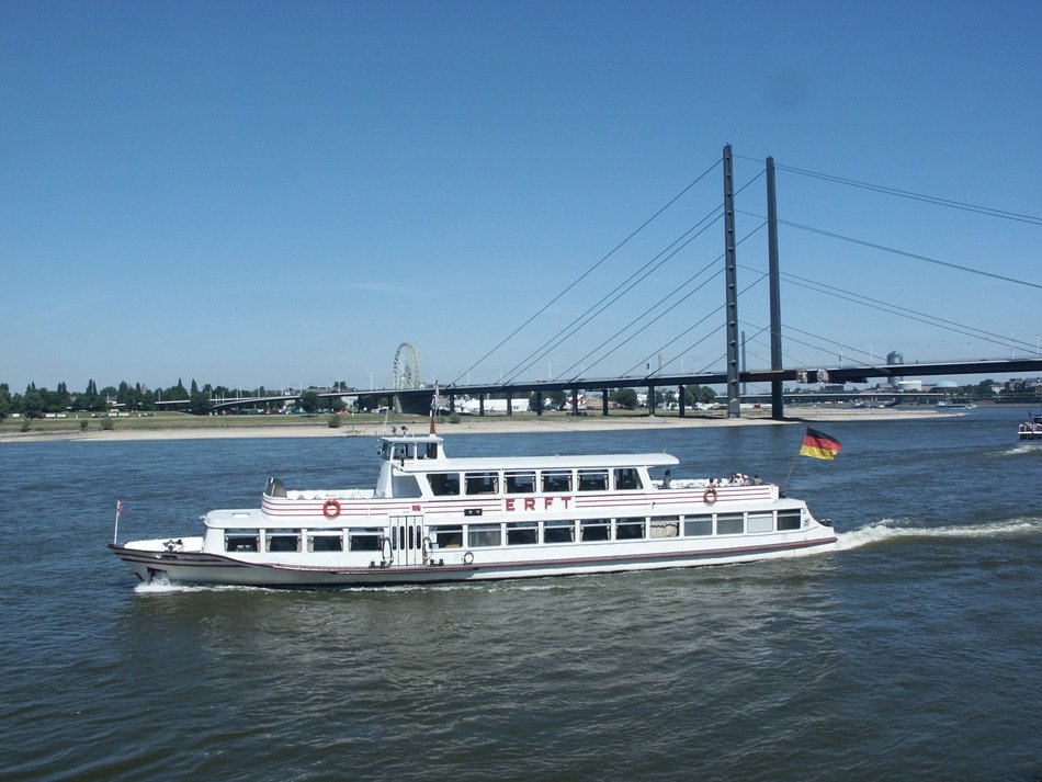 white ship on the rhine near the bridge in düsseldorf