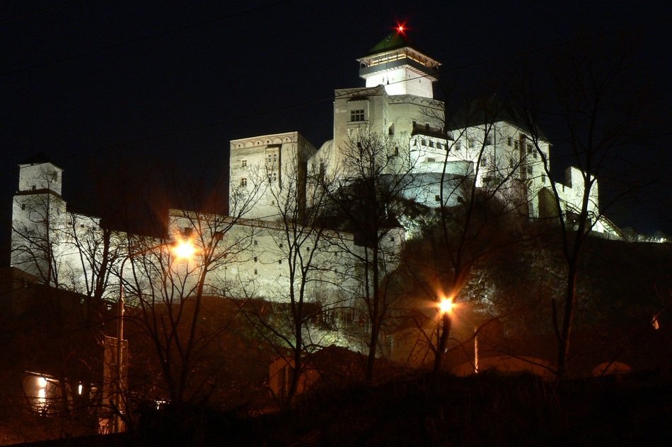 castle on the mountain at night in Slovakia